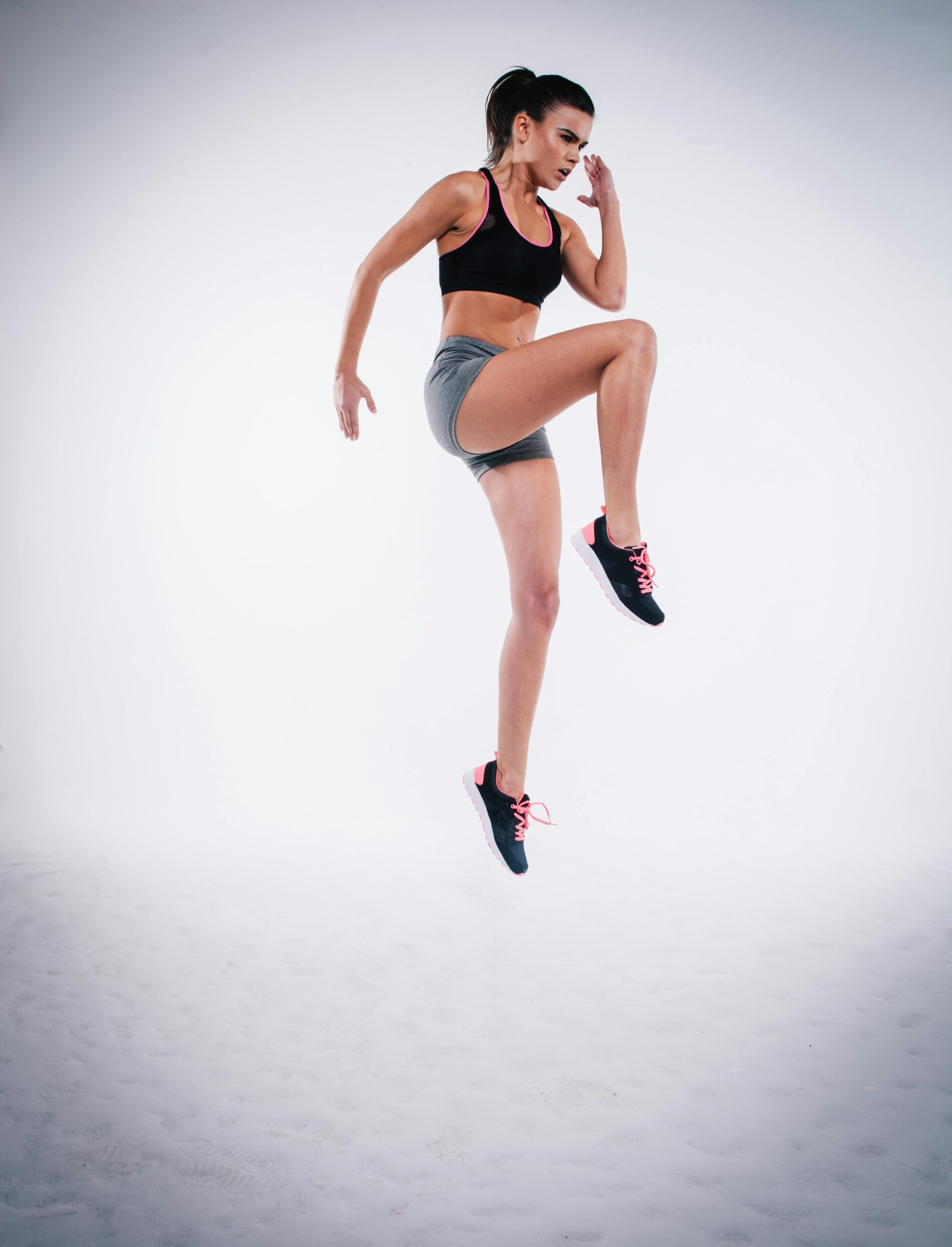 Woman Jumping on White Sand