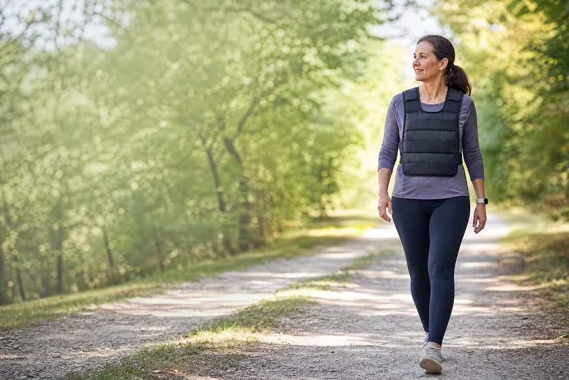 Woman wearing a weighted vest while walking outdoors